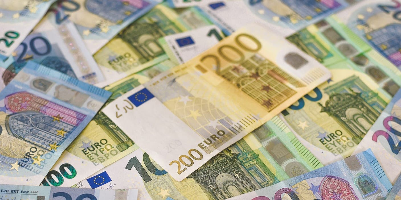 A pile of euro banknotes of different denominations